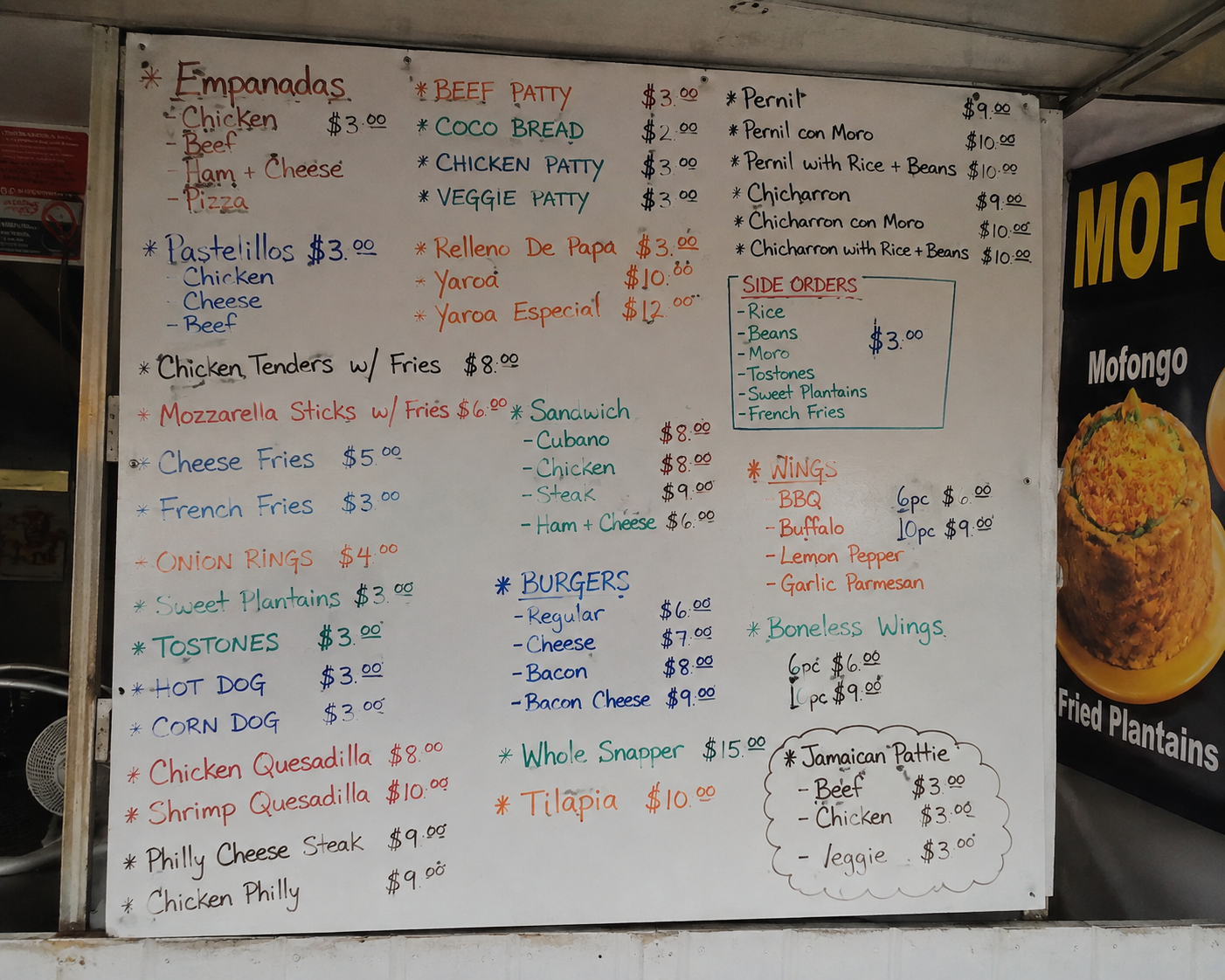 Handwritten festival food menu board crowded with items and inconsistent prices