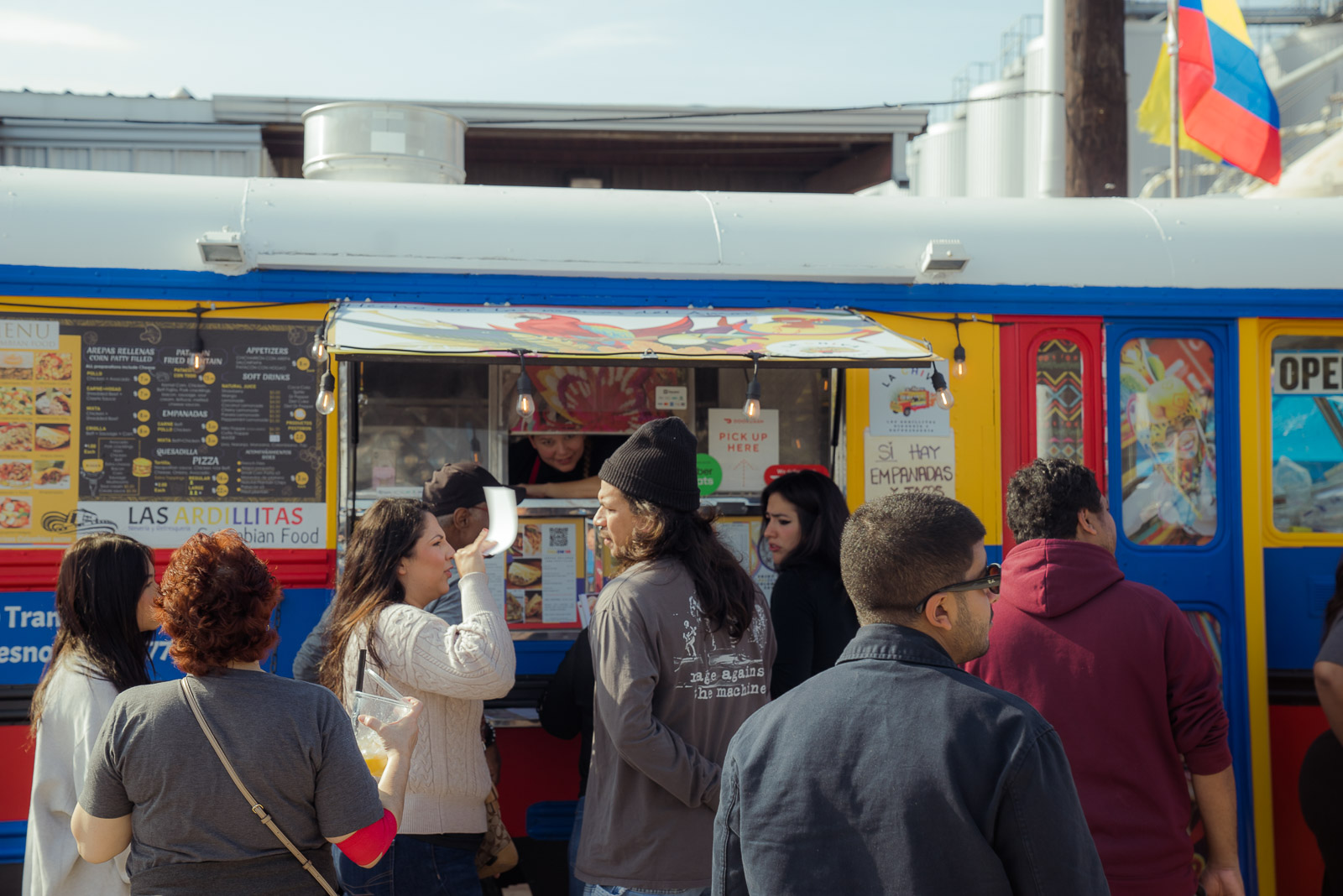 Confident vendor smiling behind a clean, busy booth